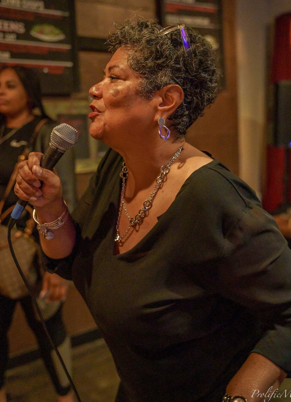 Irma Hayes speaking into a microphone at an event